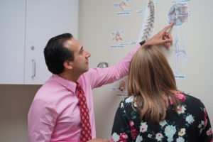 Dr Ramchandani speaks to a patient about low back pain