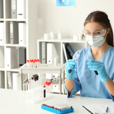 Woman in lab with test tubes