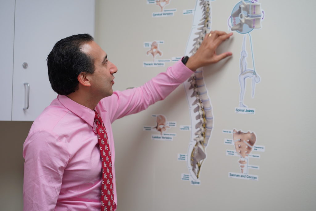 Dr Ramchandani points to a spine image